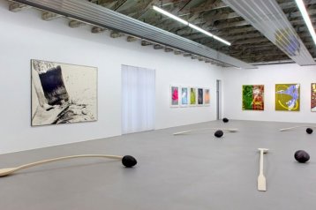 Der Kunstraum am Limes mit Gemälden und Kunstobjekten auf dem Boden ist zu sehen.